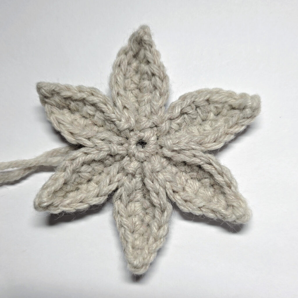 The top layer of a crochet poinsettia made for the dog collar flower.
