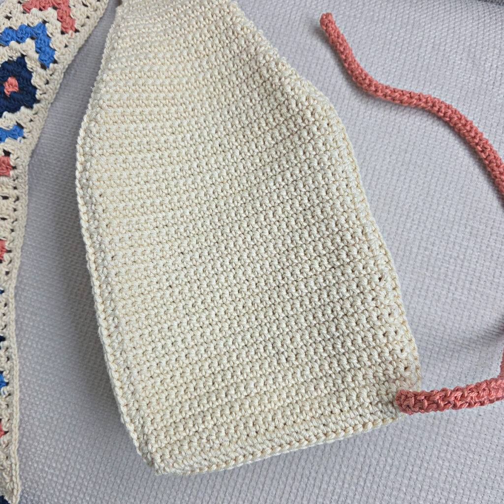 Attaching the button and strap to a crochet crossbody bag.