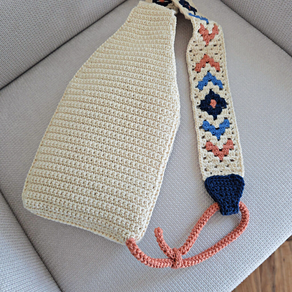 Attaching the button and strap to a crochet crossbody bag.