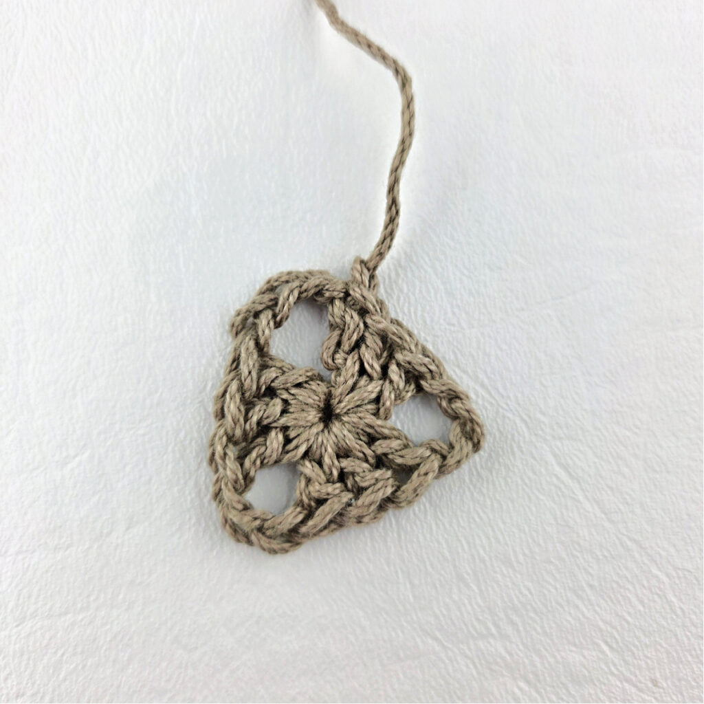 Round 1 of crochet granny stitch triangle.