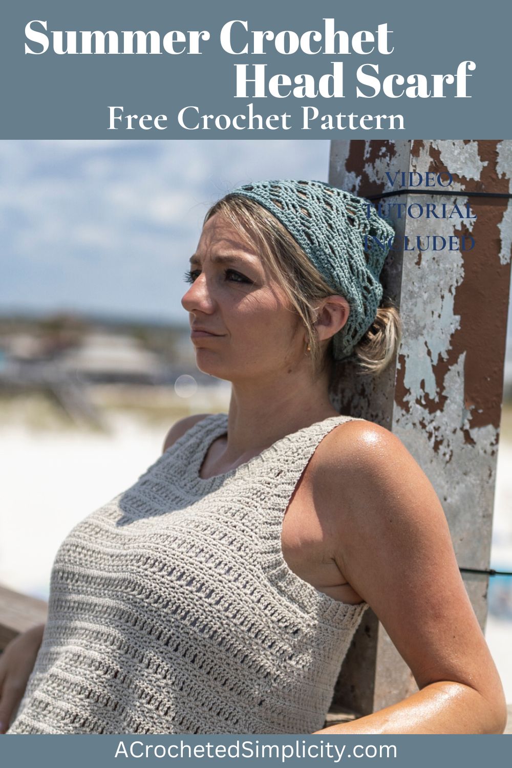 Girl leaning against a bridge wearing a grey crochet top with her hair tied back under a blue crochet bandana.