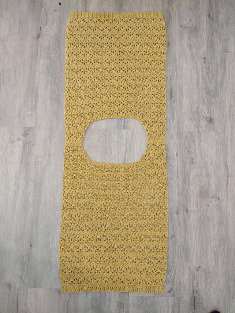 A piece of a yellow crochet tee.