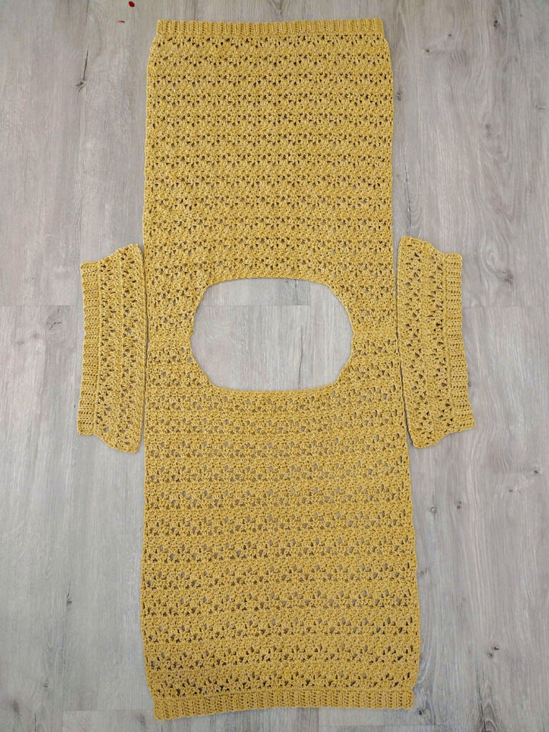 A piece of a yellow crochet tee.