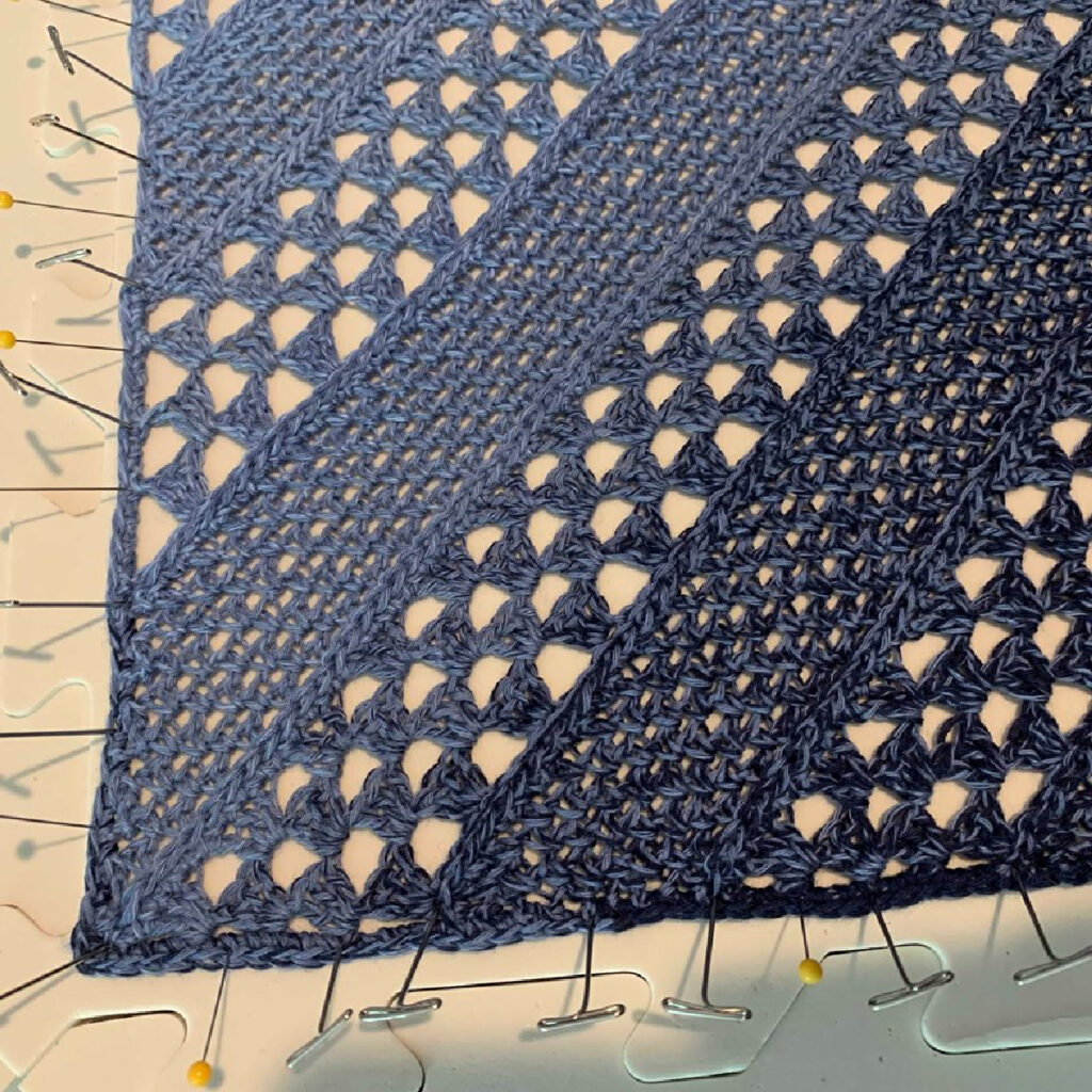 Blocking a crochet shawl.