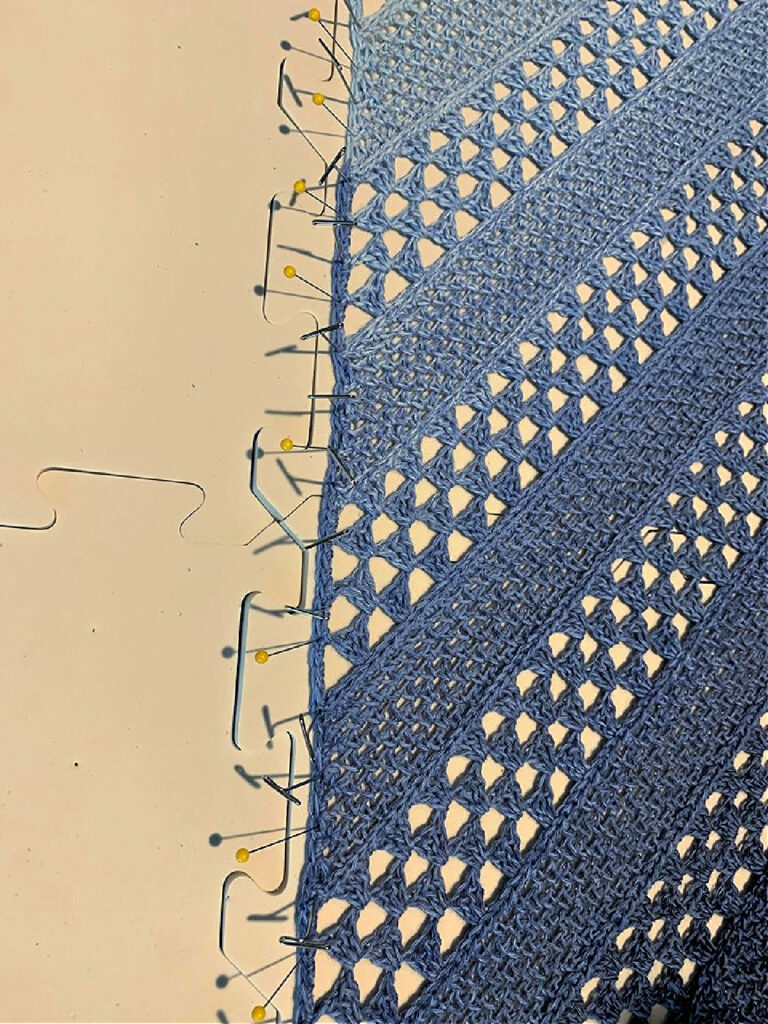 Blocking a crochet shawl.