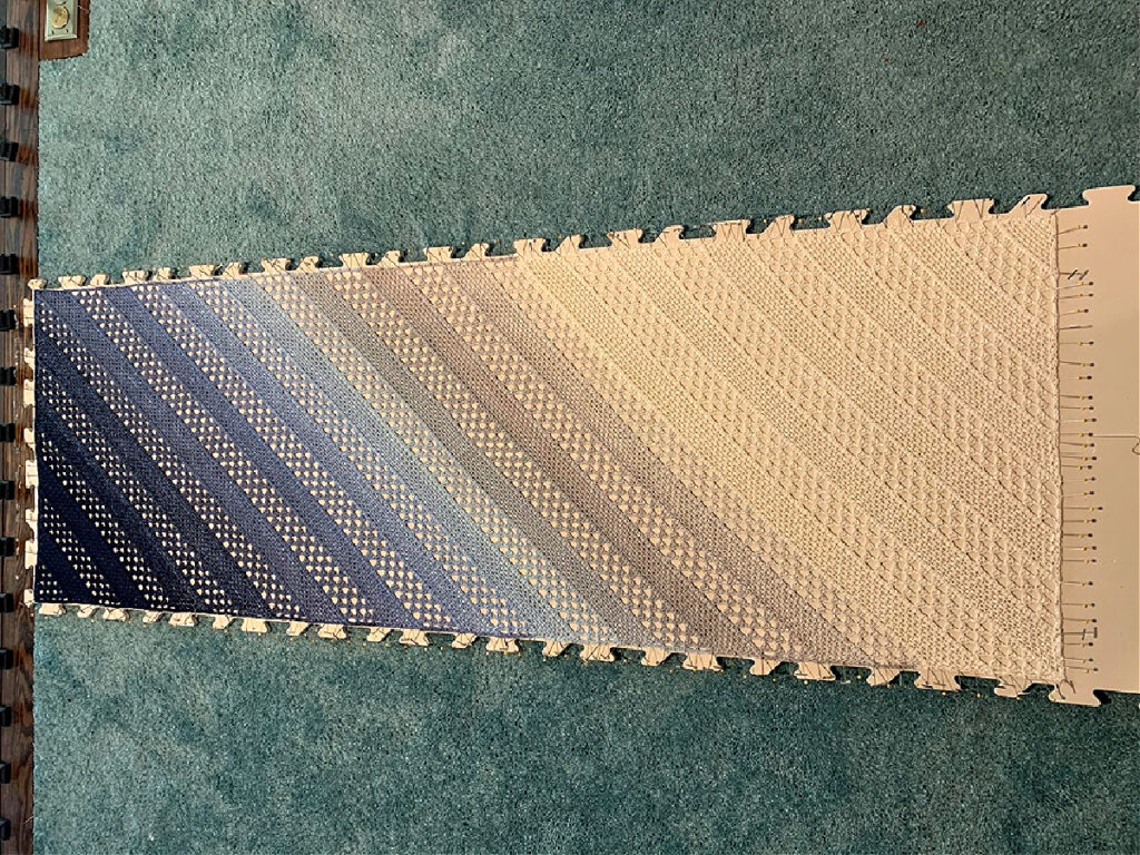 Blocking a gradient crochet shawl.
